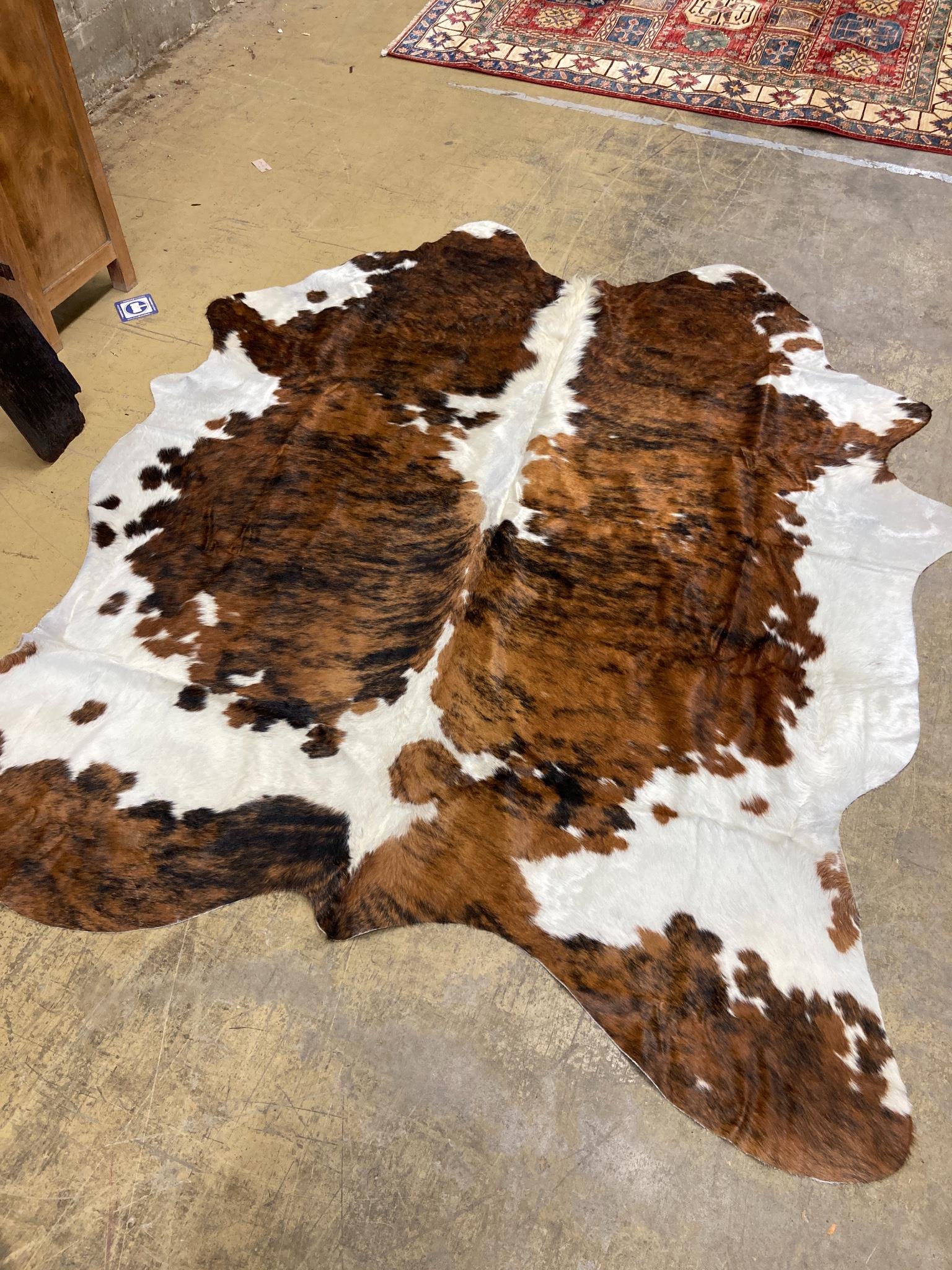 A South American cow hide rug, 215 x 185cm